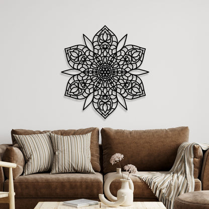 Decorative black mandala wall art on a white wall above a brown sofa.