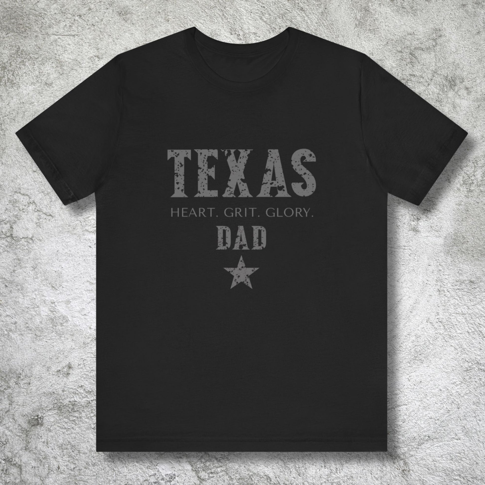 Black t-shirt with 'Texas Dad' text on a textured gray background