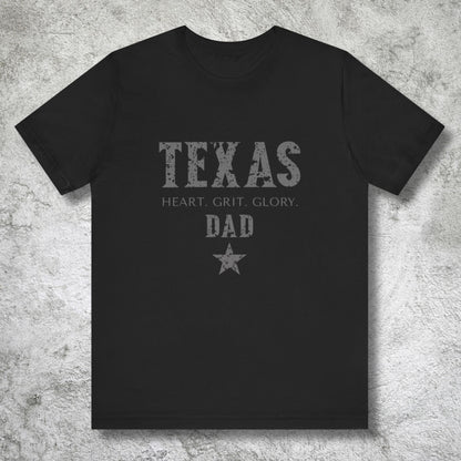 Black t-shirt with 'Texas Dad' text on a textured gray background