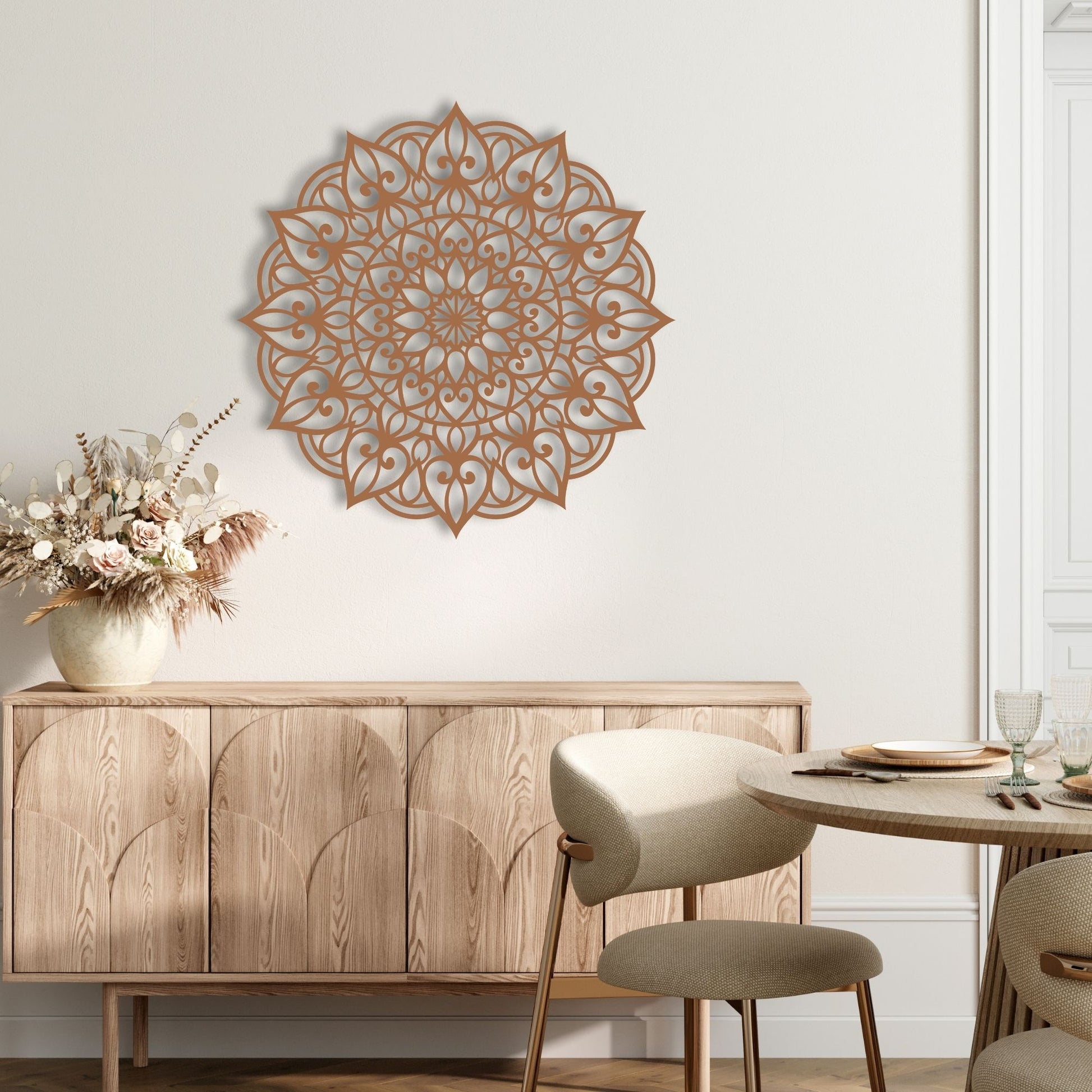 Decorative wall mandala above a wooden sideboard with a table and chairs in a room.