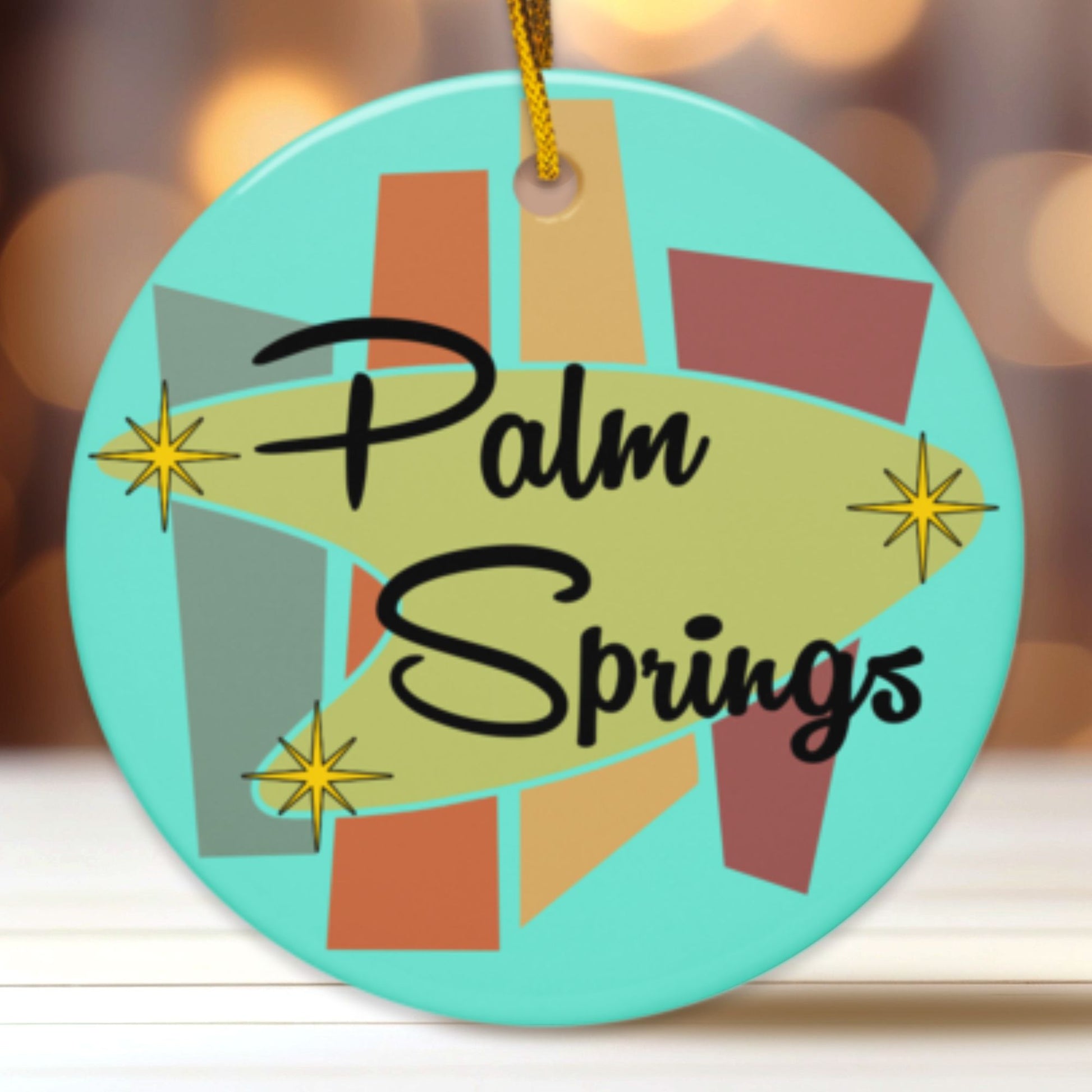Decorative ornament with 'Palm Springs' text and colorful design on a blurred background