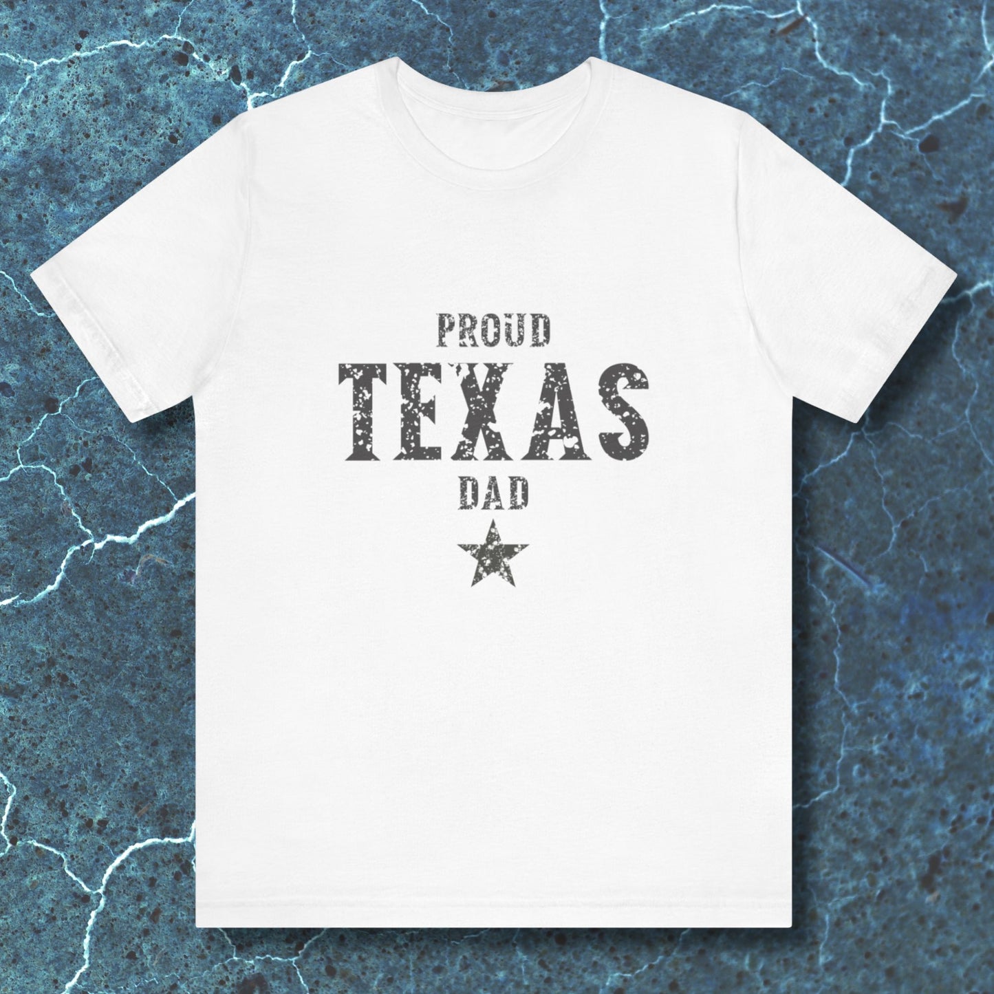 White t-shirt with 'Proud Texas Dad' text on a textured blue background