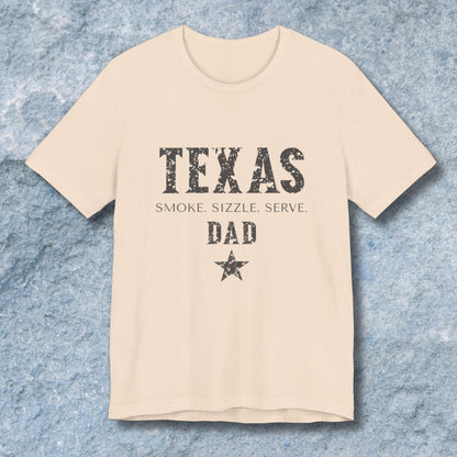 Beige t-shirt with 'Texas Dad' text on a textured blue background