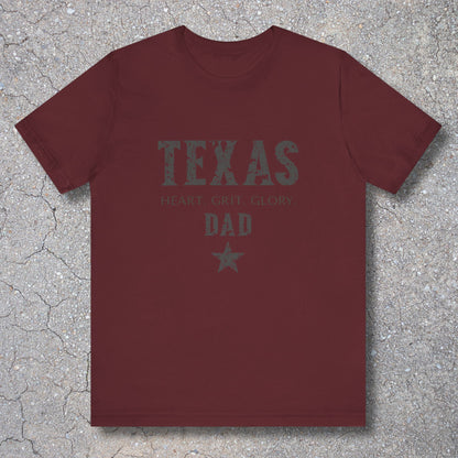 Maroon t-shirt with 'TEXAS HEART Grit Glory DAD' text on a textured surface