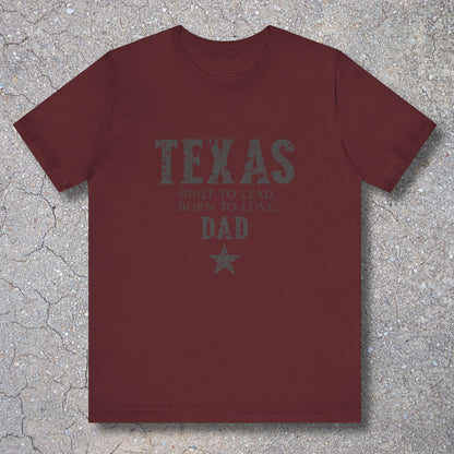 Maroon t-shirt with 'Texas Dad' text on a textured surface