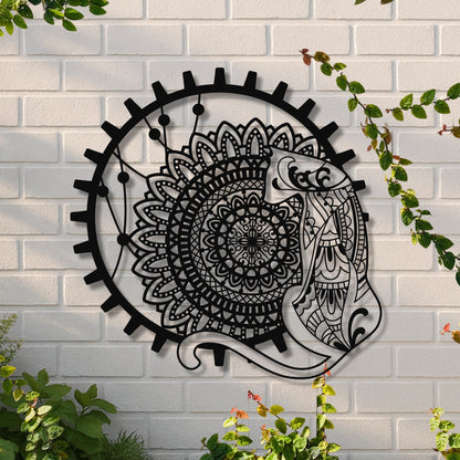 Decorative metal wall art with a fish and mandala design on a white brick wall.