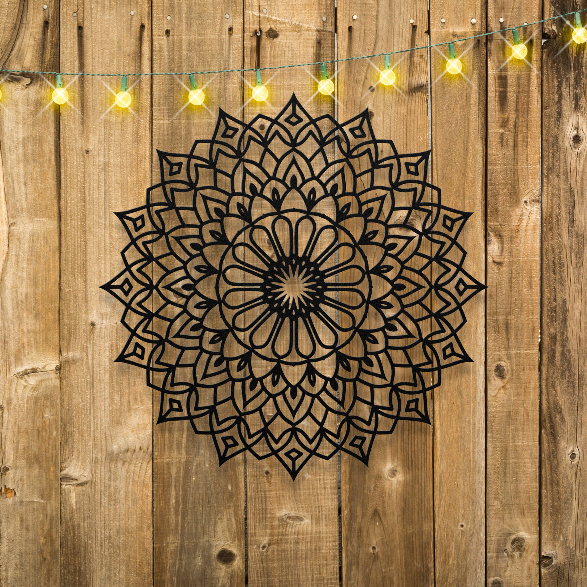 Floral Starburst Mandala Metal Wall Art on wood fence