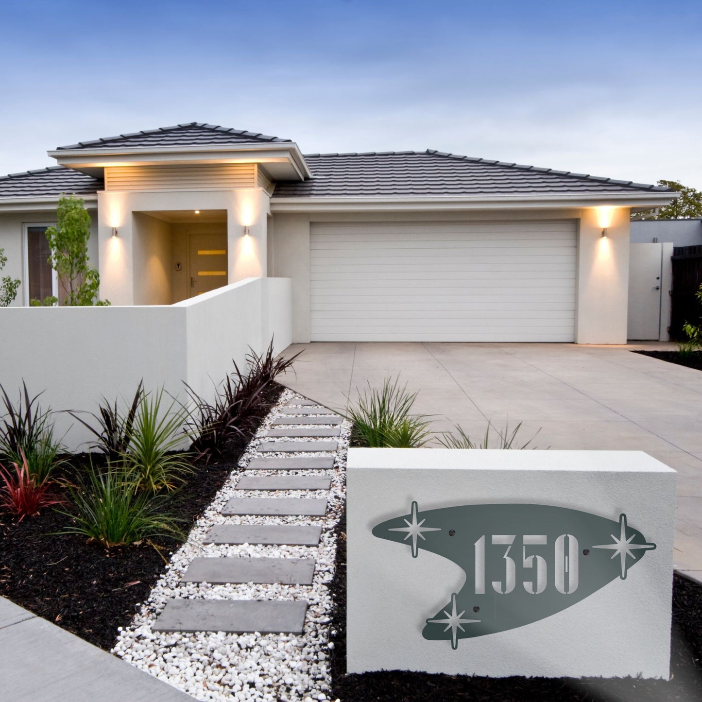 Modern house exterior with a decorative house number sign in front.