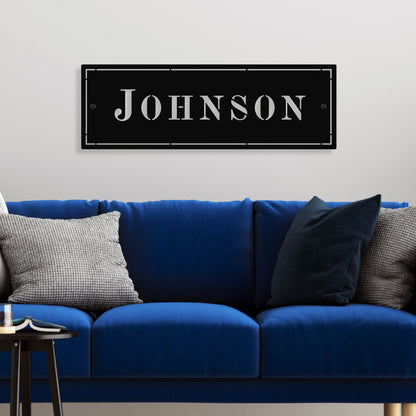 Blue sofa with decorative pillows and a sign reading 'Johnson' on the wall.