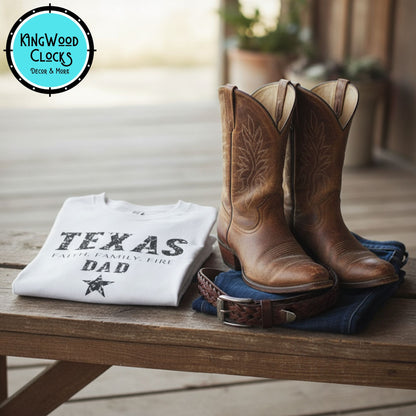 Pair of brown cowboy boots, white t-shirt with 'TEXAS DAD' text, and jeans on a wooden surface with Kingwood Clocks logo.
