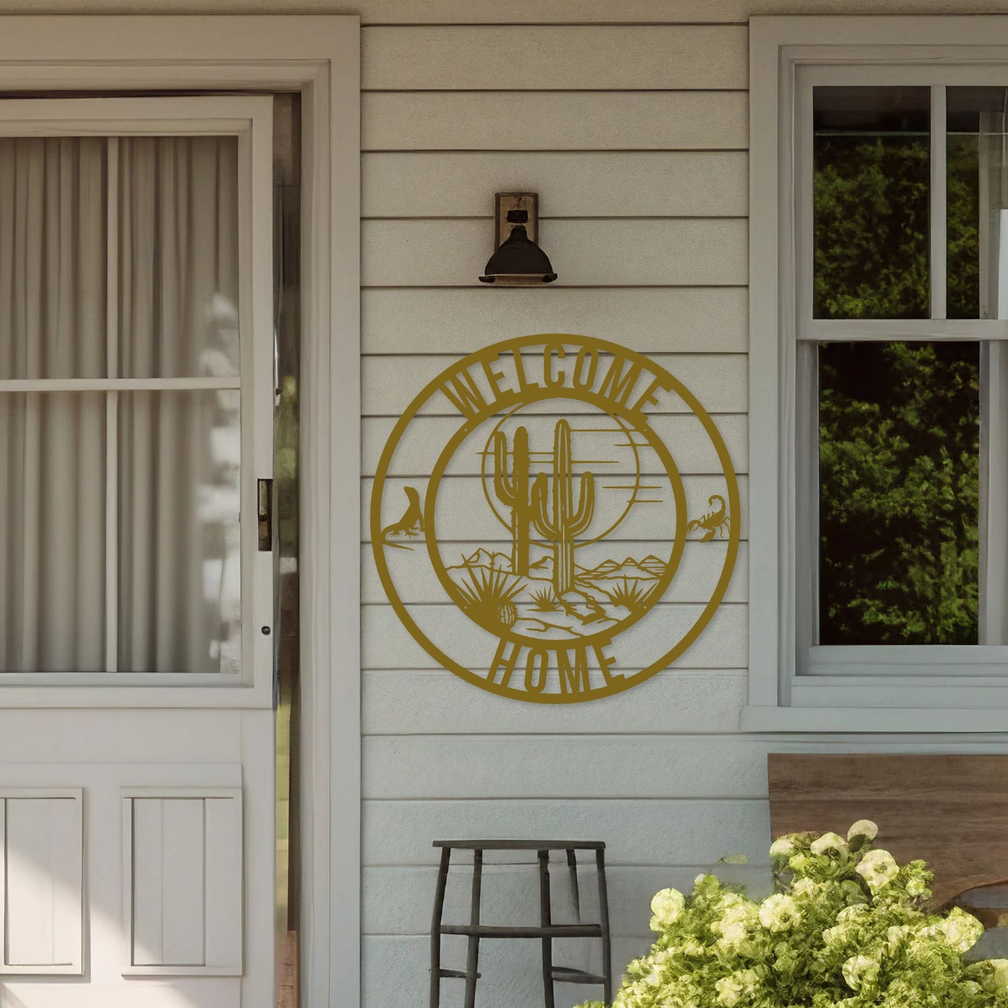 Decorative metal sign with cactus design on a wooden door