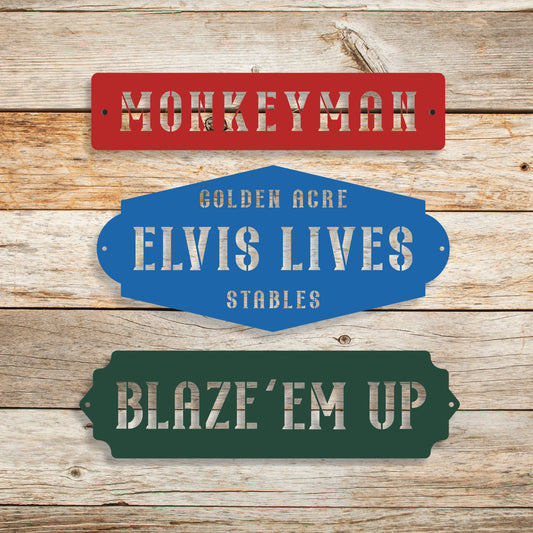 Three vintage-style metal signs with text on a wooden background