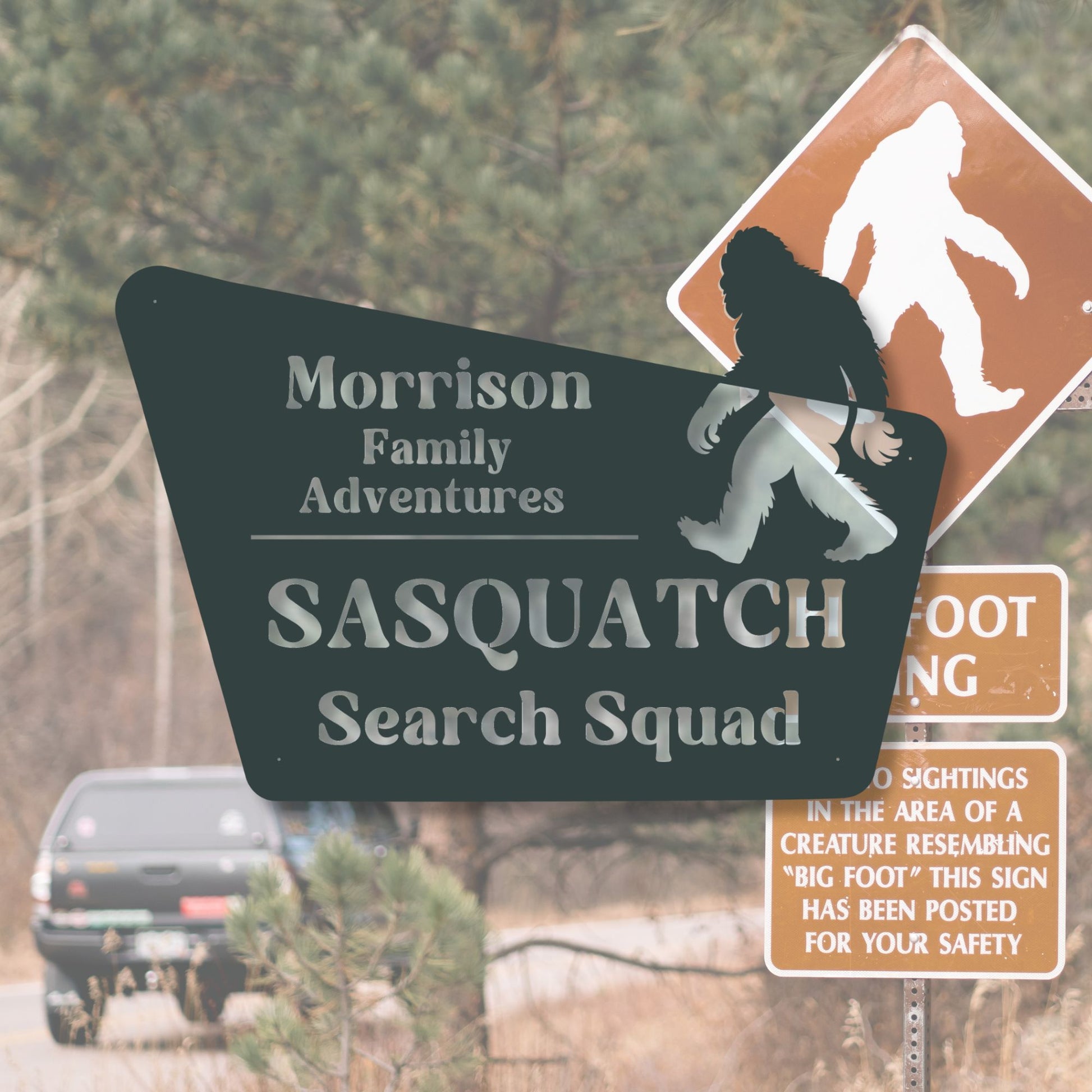 Sasquatch search squad sign with Bigfoot silhouette and road in background