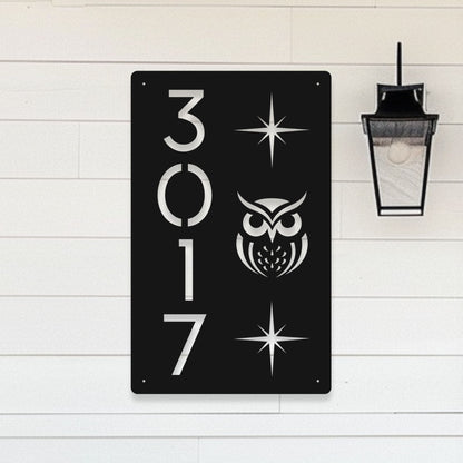 Black metal sign with white owl design and numbers '3017' on a light wooden background