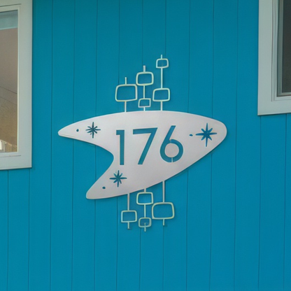 Decorative house number sign with '176' on a blue wall