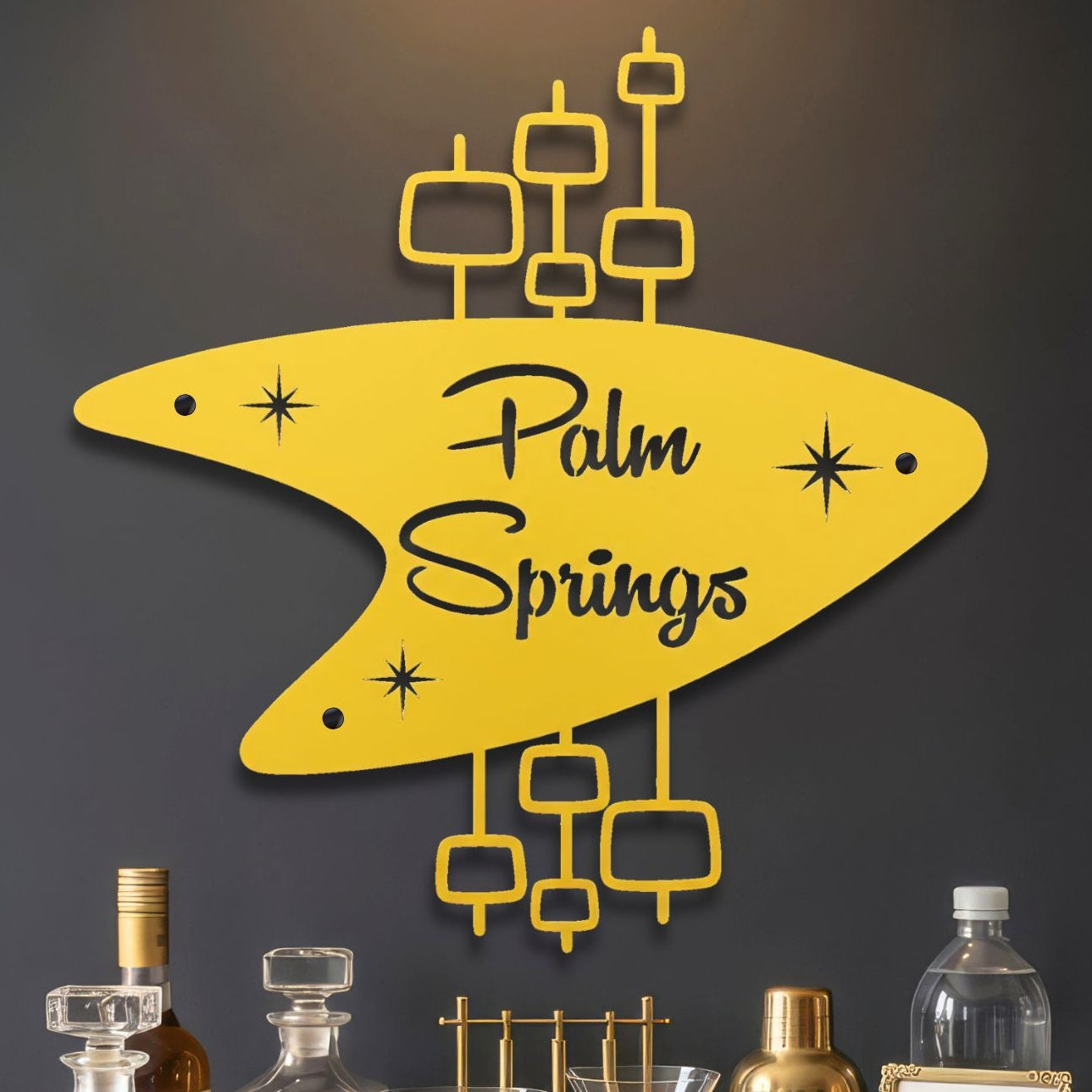 Decorative wall art with 'Palm Springs' text on a yellow background, placed above a bar setup.