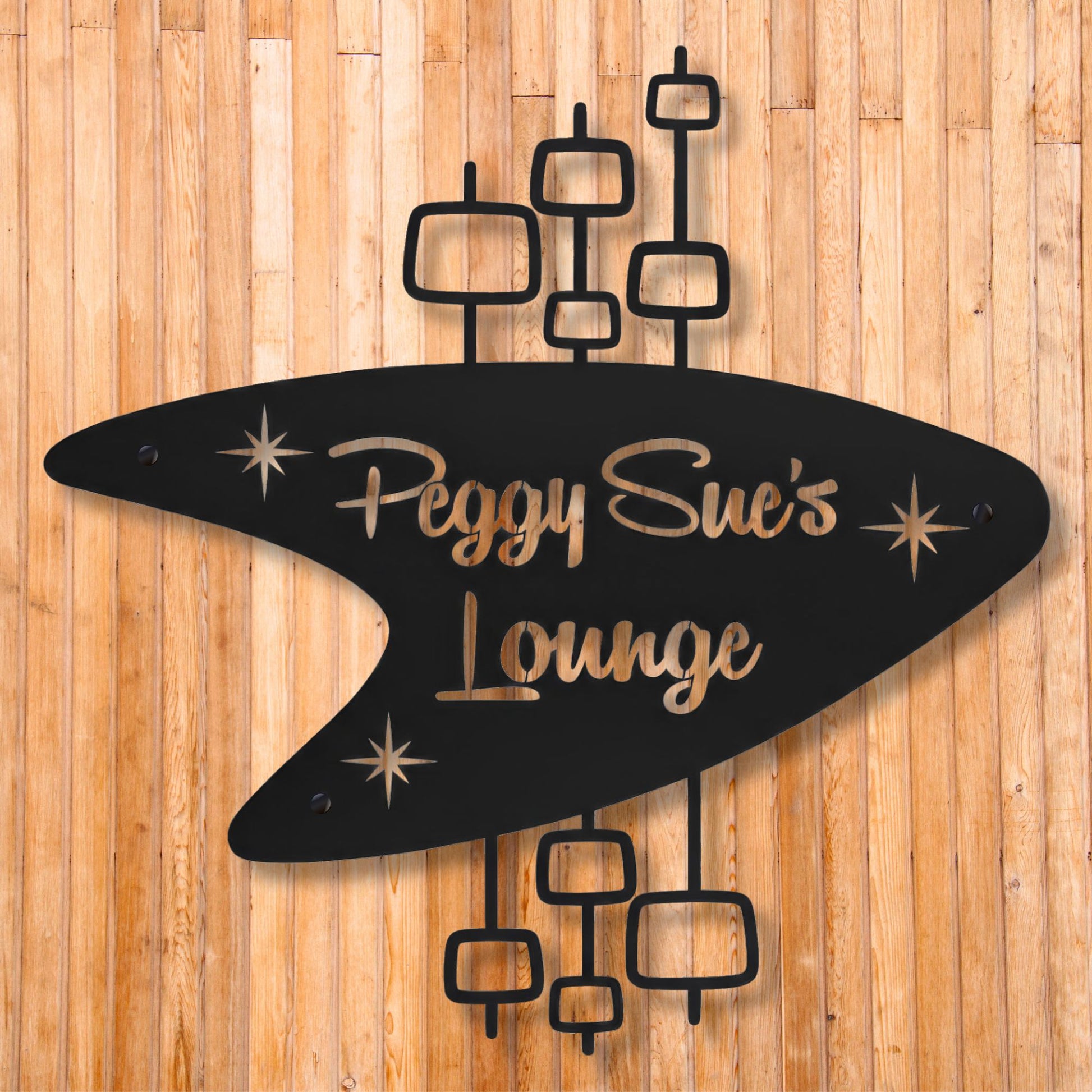 Decorative sign with 'Peggy Sue's Lounge' on a wooden background