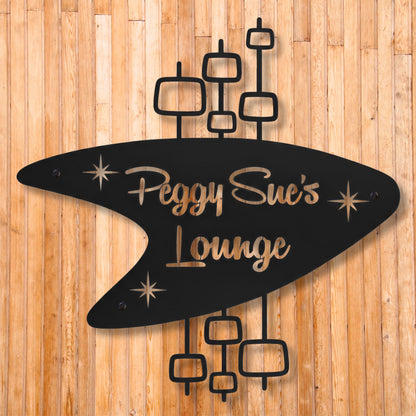 Decorative sign with 'Peggy Sue's Lounge' on a wooden background