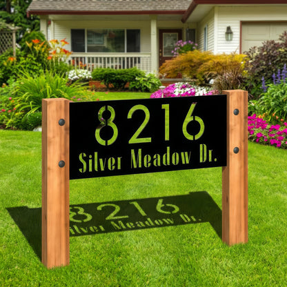House number sign with '8216 Silver Meadow Dr.' on a grassy lawn in front of a house.