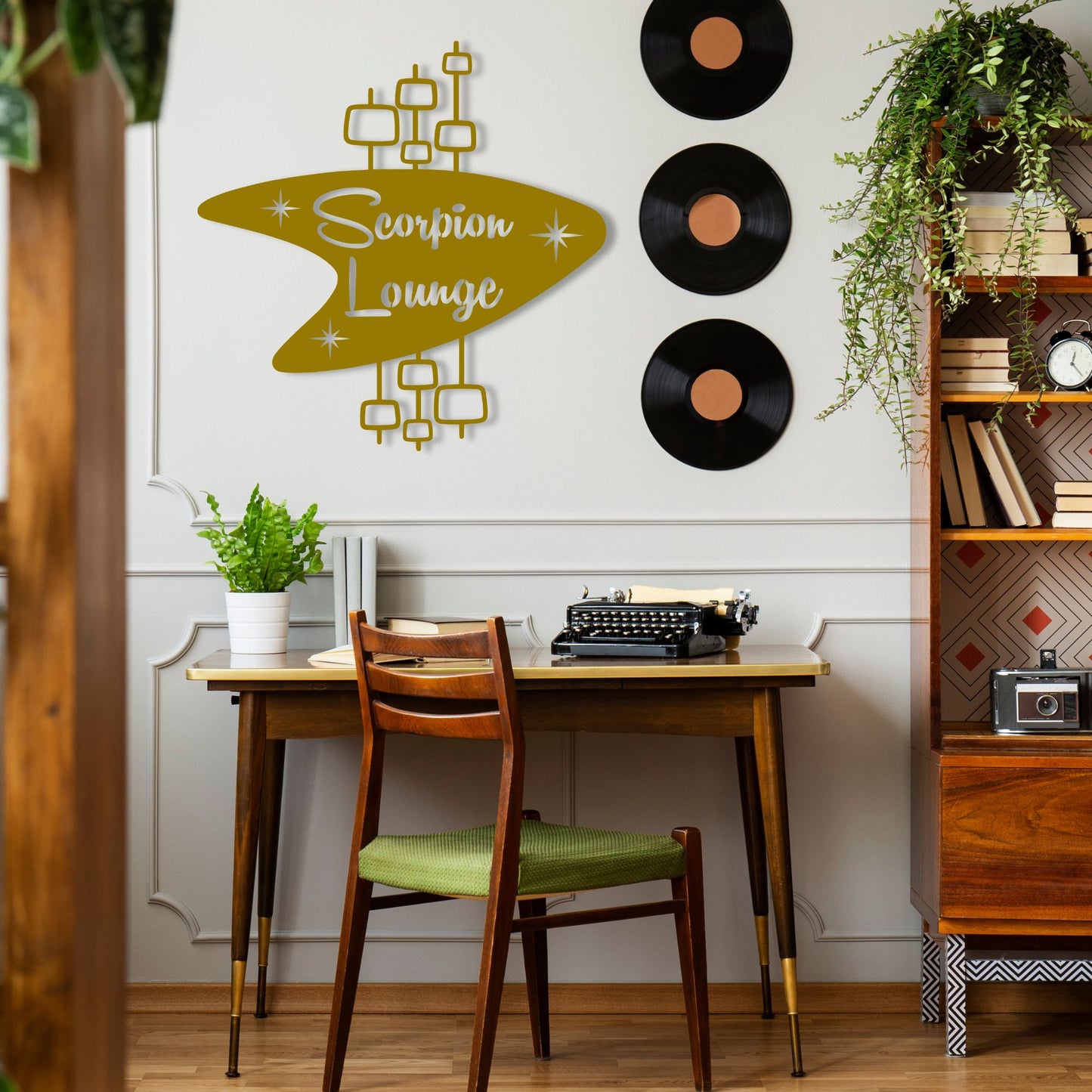 Gold Personalized Mid Century Modern Name Sign shown hanging over hipster desk in office space