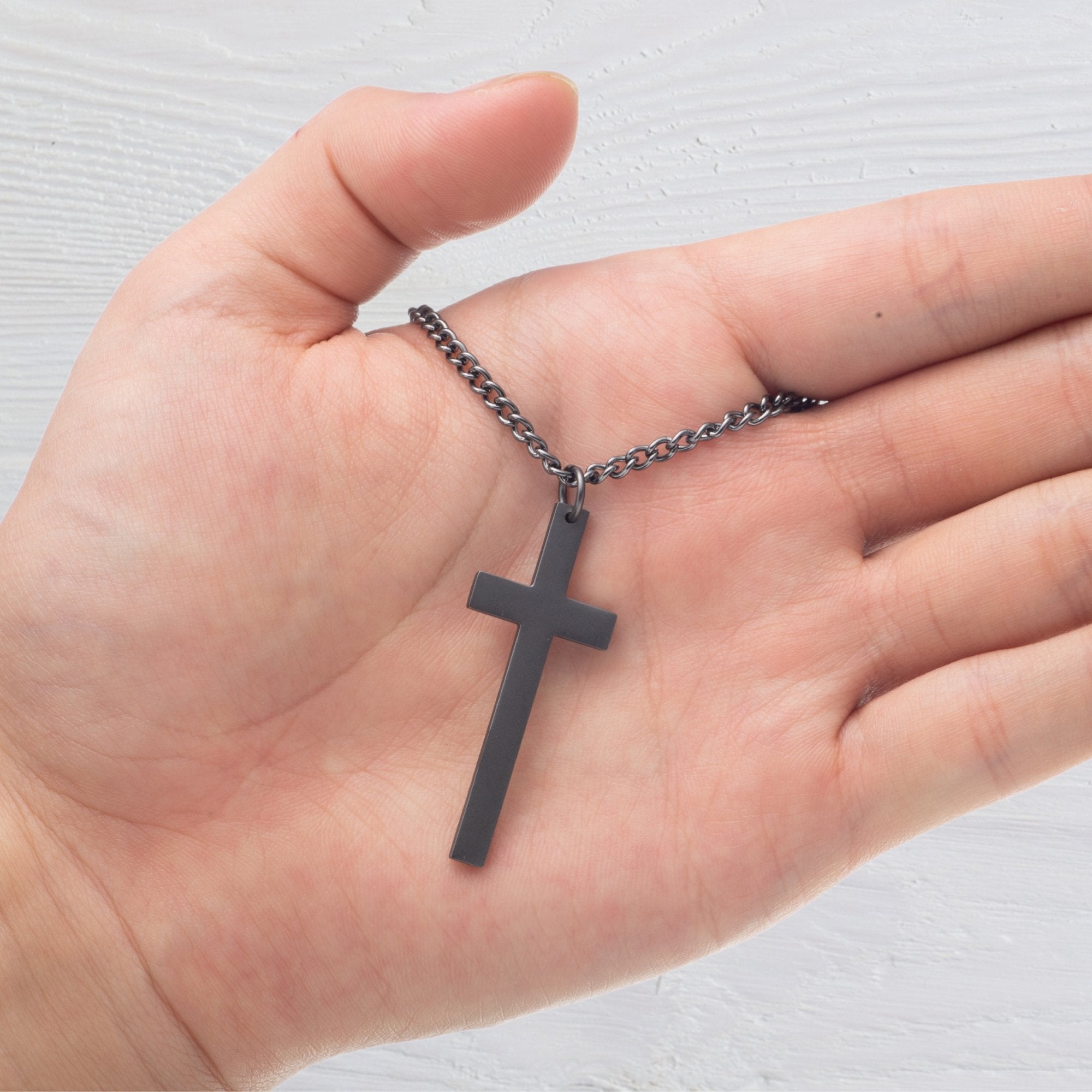 Sacred Cross Necklace, Bible Verse Psalm 61:2, Glacier National Park gun metal black in hand