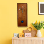 Load image into Gallery viewer, KingWood Pendulum Wall Clock In Cedar &amp; Blue on yellow wall in living room
