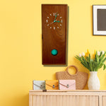 Load image into Gallery viewer, KingWood Pendulum Wall Clock In Cedar &amp; Turquoise on yellow living room wall
