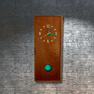 KingWood Pendulum Wall Clock In Cedar & Turquoise brick wall