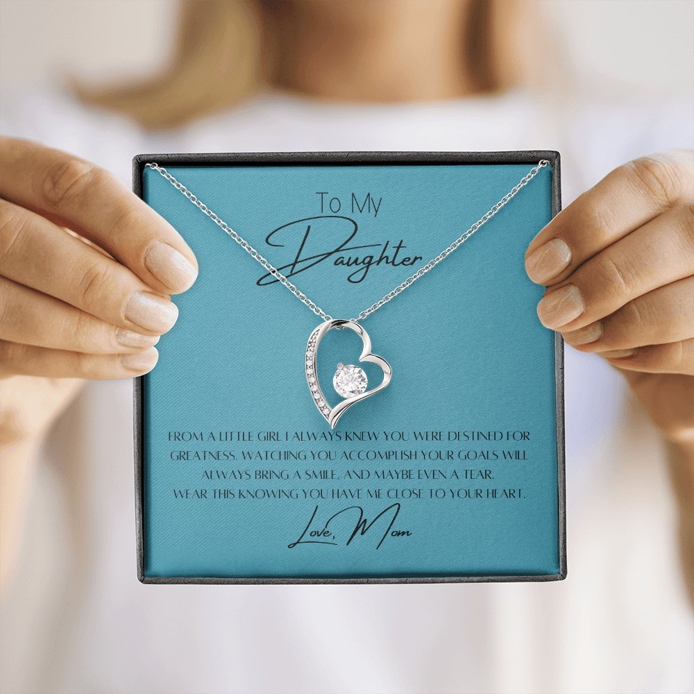To My Daughter Heart Necklace & Gift Message, From Mom, Blue held up by mom to daughter gifting