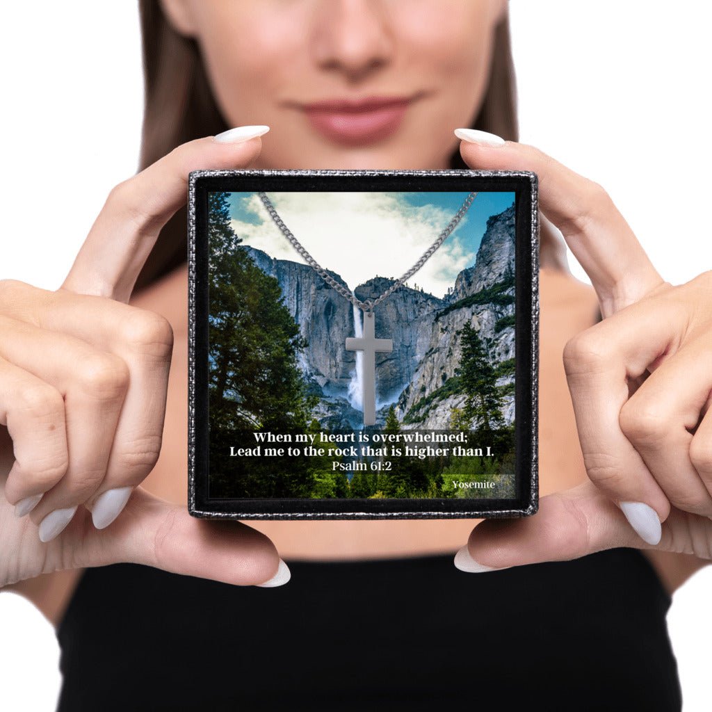 Sacred Cross Necklace, Bible Verse Psalm 61:2, Yosemite Falls held by woman to gift to her man